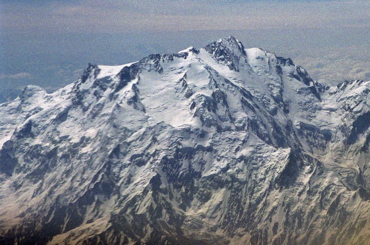 08 Nanga Parbat Diamir Face And Summit Close Up On Flight From Islamabad To Skardu The plane continues flying around Nanga Parbat with Rakhiot Peak, the East Peak, the Silver Plateau, the North Peaks, the summit above the Diamir Face and the beginning of the Mazeno Ridge on the far right.